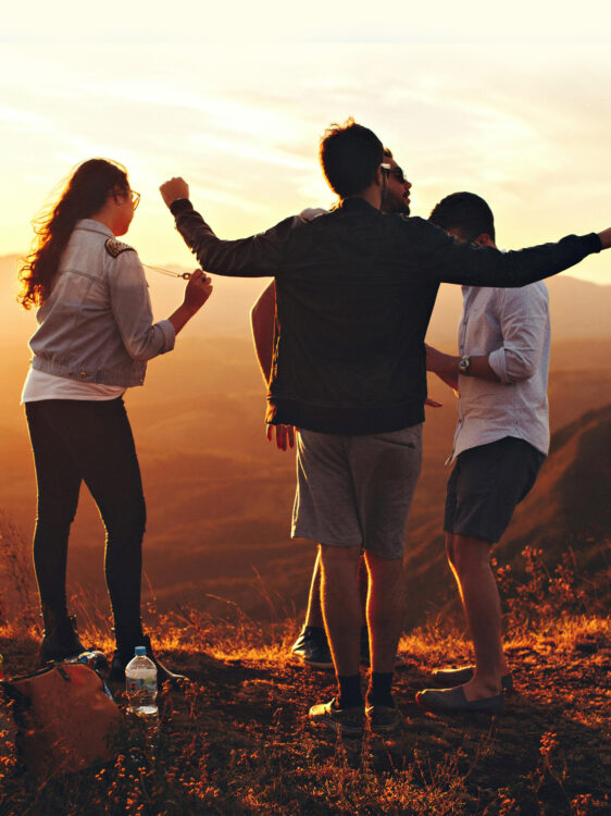 Holidaymakers dancing at sunset